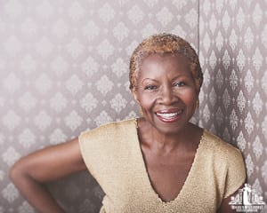 Image of an older woman smiling at the camera during a portrait session by Vancouver contemporary portrait photographer Angela McConnell