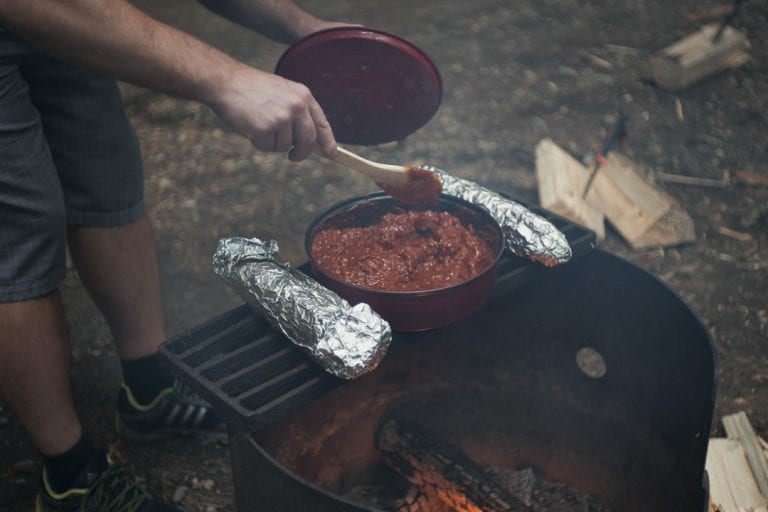 Spaghetti being stirred while warming over a campfire at Golden Ears Provincial Park