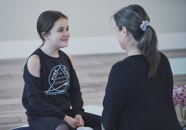 Wildflower Retreats for Mums and tweens |Photography by Angela McConnell A young girl smiles at her mother as she sits directly across from her during an exercise at a mother and daughter workshop by Vancouver workshop and retreat photographer Angela McConnell